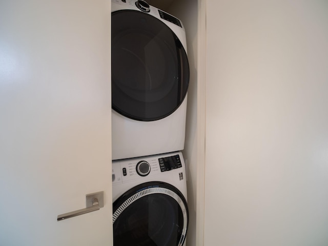 laundry area featuring stacked washer / drying machine