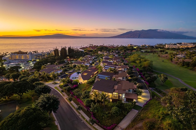 aerial view at dusk with a water and mountain view