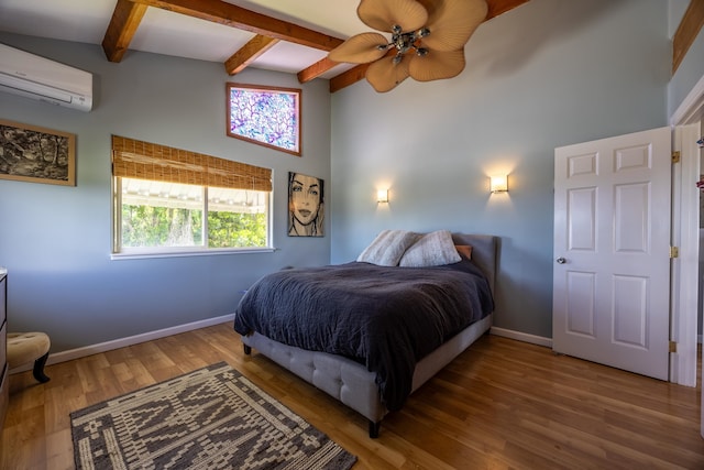 bedroom featuring beamed ceiling, a wall mounted AC, hardwood / wood-style flooring, and ceiling fan