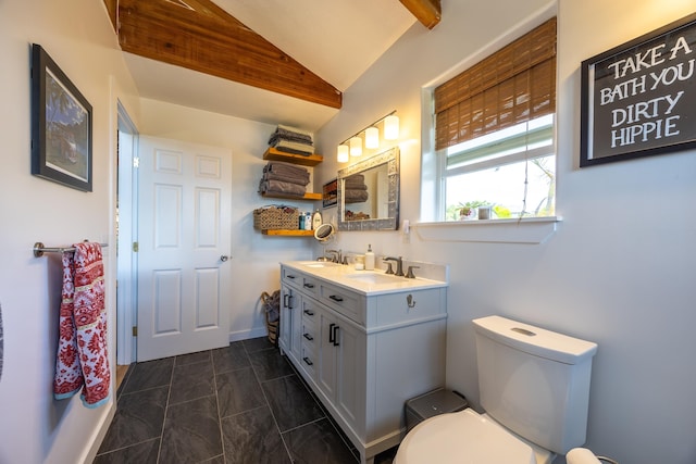 bathroom with vanity, toilet, and lofted ceiling