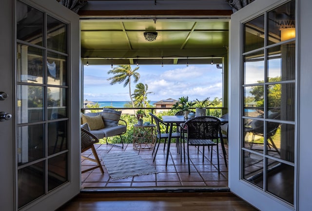 entryway featuring dark hardwood / wood-style floors and a water view