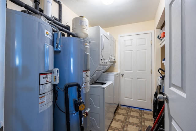 utilities featuring water heater and stacked washer and clothes dryer