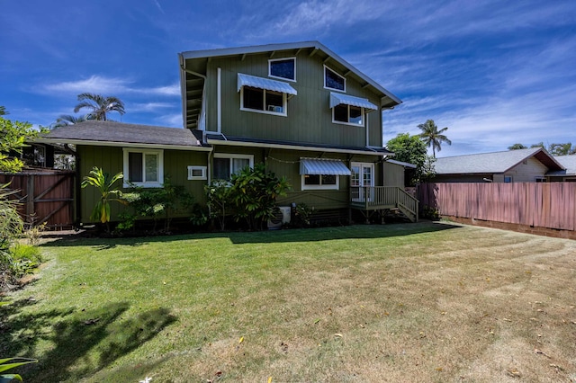 back of house with a lawn