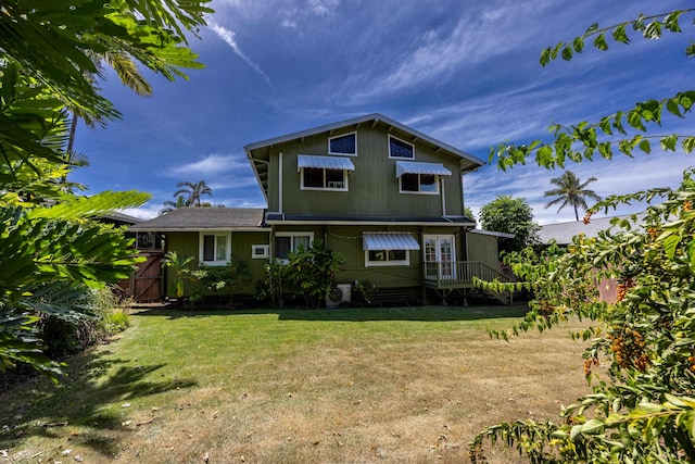 rear view of house with a lawn