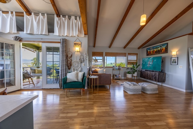 living room with vaulted ceiling with beams and hardwood / wood-style floors