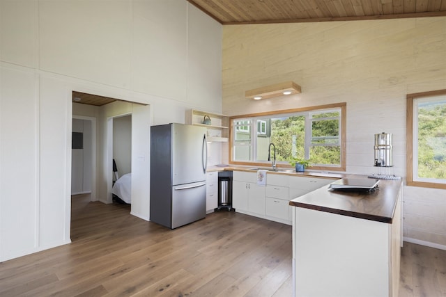 34701 Piilani Hwy, Hana, HI 96713 - kitchen with freestanding refrigerator, high vaulted ceiling, a sink, light wood finished floors, and wooden ceiling
