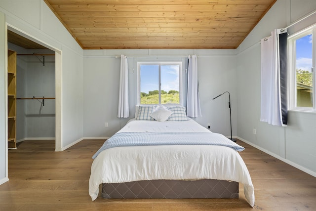 34701 Piilani Hwy, Hana, HI 96713 - bedroom with vaulted ceiling, wooden ceiling, multiple windows, wood finished floors, and baseboards