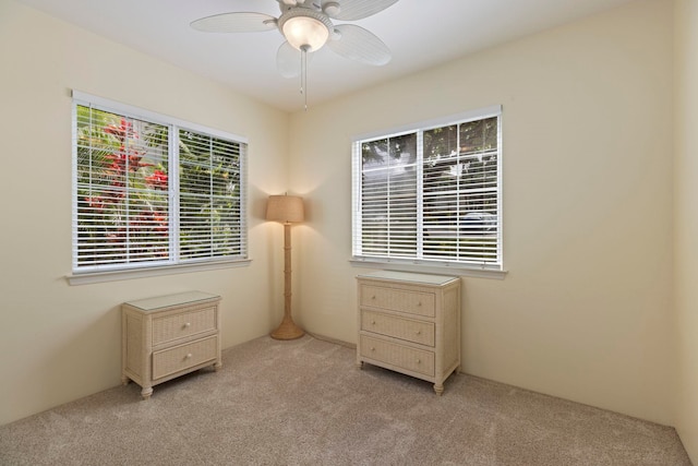 interior space featuring ceiling fan and light carpet