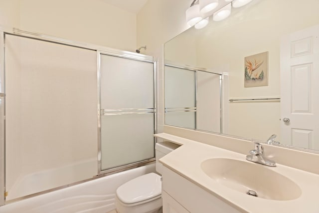 full bathroom featuring bath / shower combo with glass door, toilet, and vanity