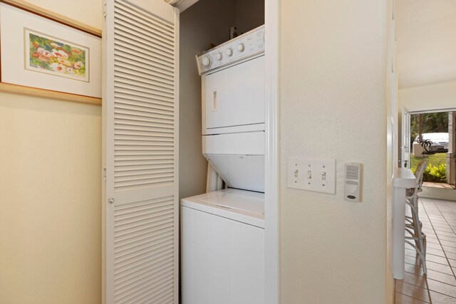 laundry area featuring stacked washer / drying machine