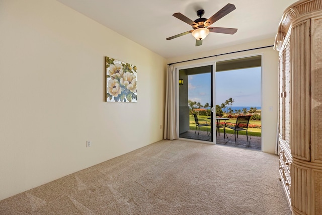 carpeted empty room featuring ceiling fan