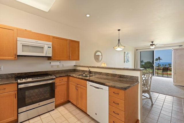 kitchen featuring white appliances, light tile patterned floors, sink, kitchen peninsula, and pendant lighting