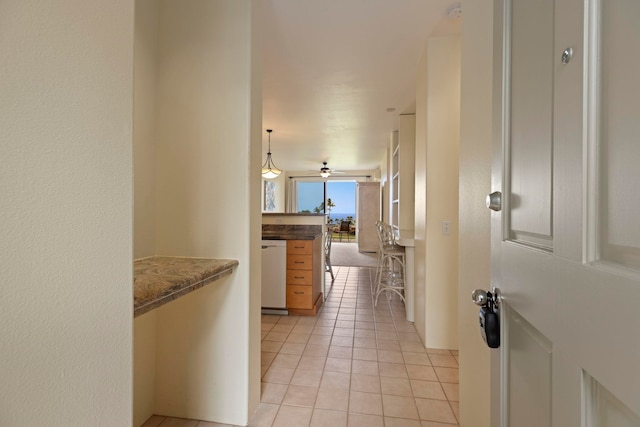 corridor with light tile patterned flooring