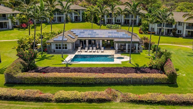 back of house with a yard, solar panels, and a patio