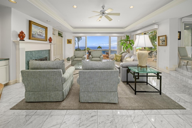 212 Crestview Rd, Lahaina, HI 96761 - living room featuring marble look tiles, a tray ceiling, a ceiling fan, healthy amount of natural light, and crown molding