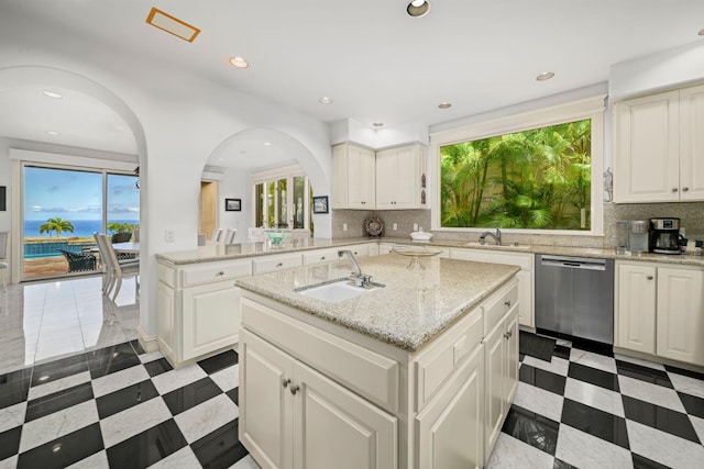 212 Crestview Rd, Lahaina, HI 96761 - kitchen with stainless steel dishwasher, arched walkways, a center island with sink, backsplash, and recessed lighting