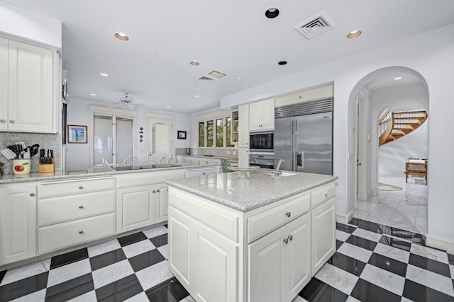 212 Crestview Rd, Lahaina, HI 96761 - kitchen featuring black appliances, a ceiling fan, a center island, backsplash, and white cabinets