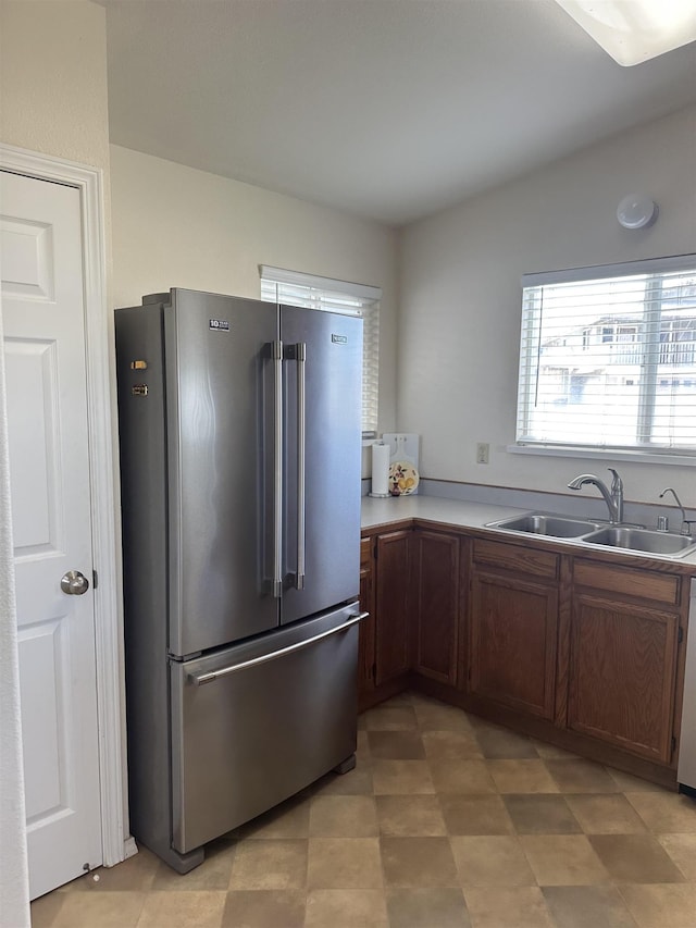 kitchen with a sink, appliances with stainless steel finishes, and light countertops