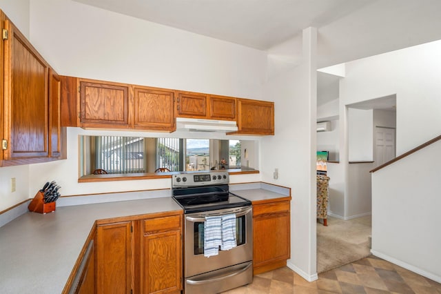 1125 Hoomau Pl, Wailuku, HI 96793 - kitchen with stainless steel electric stove, brown cabinetry, under cabinet range hood, baseboards, and light countertops