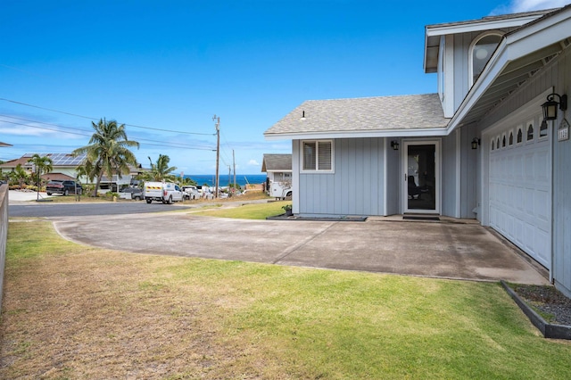 1125 Hoomau Pl, Wailuku, HI 96793 - entrance to property with a yard, roof with shingles, and board and batten siding