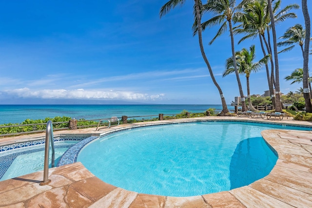 view of swimming pool with a water view