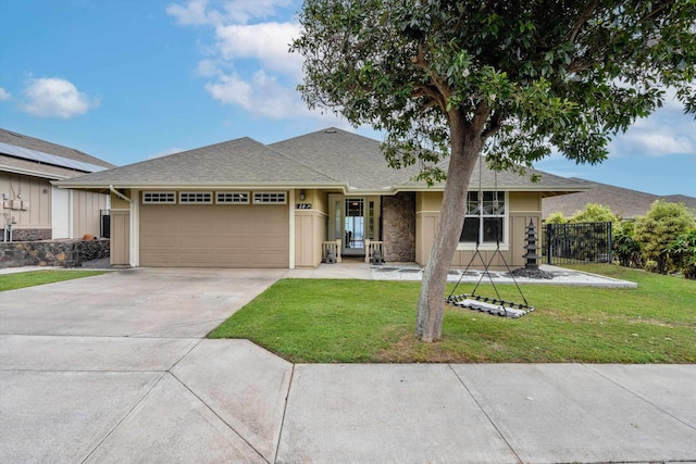 ranch-style house with a garage and a front lawn