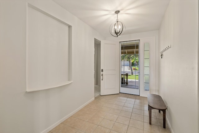 foyer entrance with light tile patterned flooring and a chandelier