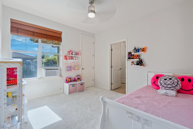 bedroom with cooling unit, ceiling fan, and light carpet