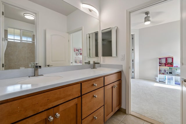 bathroom featuring tile patterned flooring, vanity, and ceiling fan