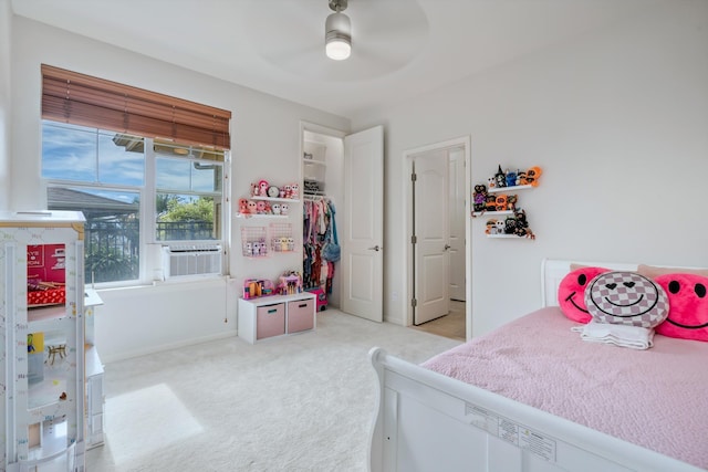 bedroom featuring light carpet, cooling unit, and ceiling fan