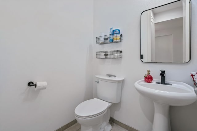 bathroom with tile patterned floors and toilet