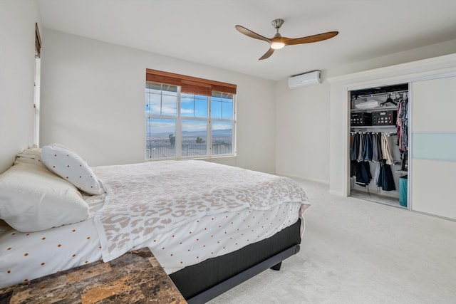 carpeted bedroom featuring a wall mounted AC, ceiling fan, and a closet