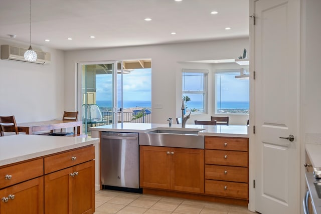 kitchen featuring dishwasher, sink, hanging light fixtures, light tile patterned floors, and a wall unit AC