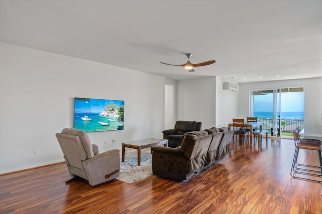 living room with ceiling fan, dark hardwood / wood-style flooring, and a wall unit AC