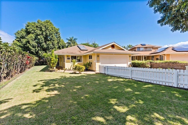 ranch-style home with a garage, a front lawn, and solar panels