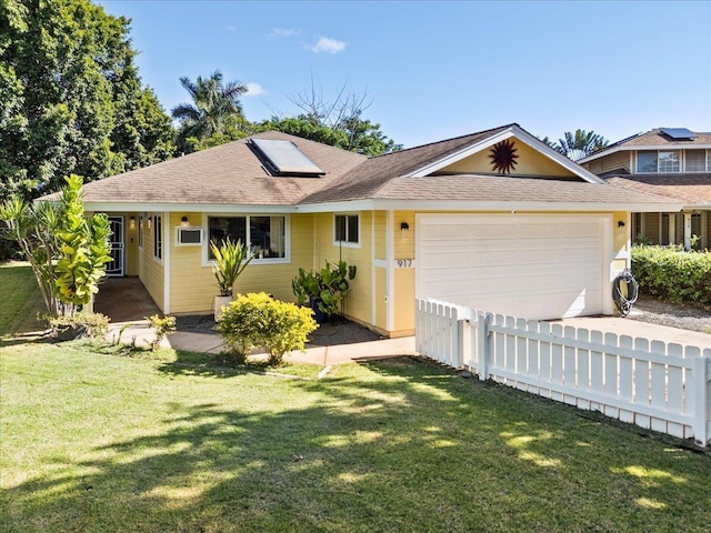 ranch-style home with a garage and a front lawn