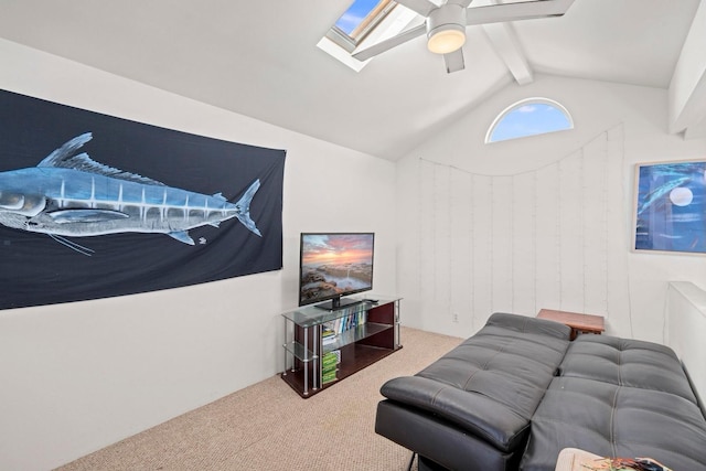 carpeted living room with lofted ceiling with skylight and ceiling fan