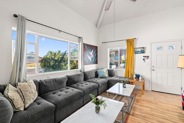 living room featuring beam ceiling, ceiling fan, high vaulted ceiling, and light wood-type flooring