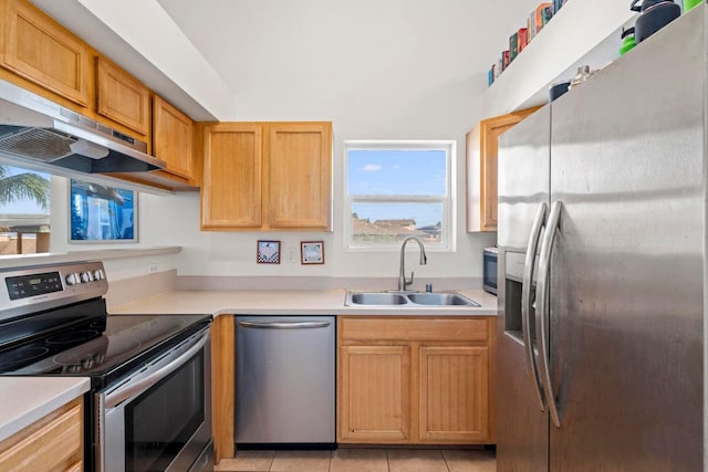 kitchen with light tile patterned flooring, sink, stainless steel appliances, and extractor fan