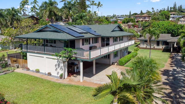 487 Hoala Dr, Kihei, HI 96753 - back of house with solar panels, driveway, roof with shingles, a lawn, and stucco siding