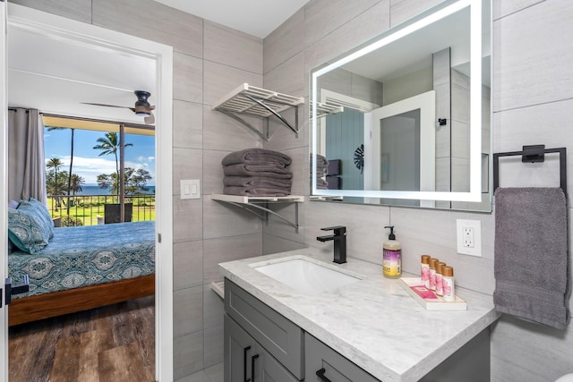 bathroom with vanity, hardwood / wood-style flooring, and ceiling fan