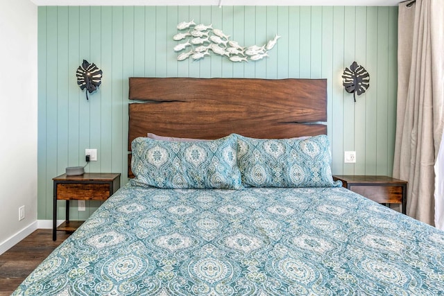 bedroom with dark hardwood / wood-style flooring