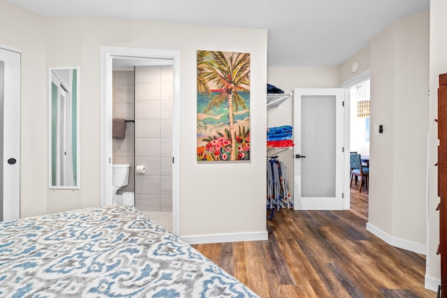 bedroom with dark hardwood / wood-style flooring and ensuite bath