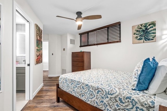 bedroom with ceiling fan, dark hardwood / wood-style flooring, and ensuite bathroom