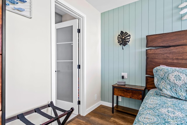 bedroom with dark hardwood / wood-style floors