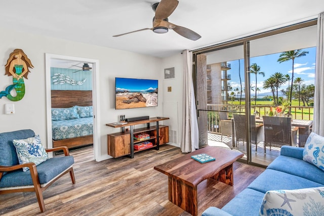 living room featuring ceiling fan and hardwood / wood-style floors