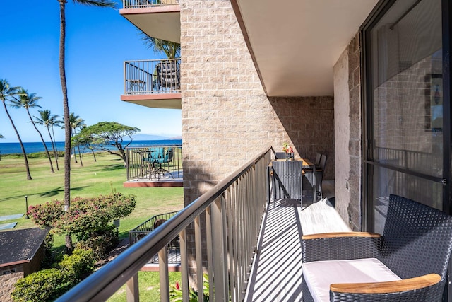 balcony featuring a water view