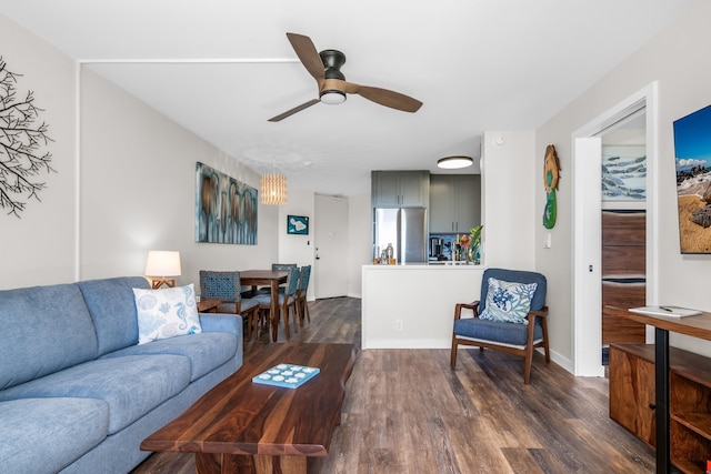 living room with ceiling fan and dark hardwood / wood-style flooring