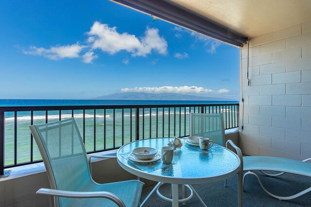 balcony featuring a water view