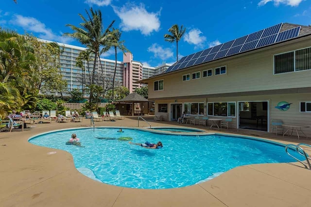 community pool featuring a patio area, a hot tub, and a gazebo